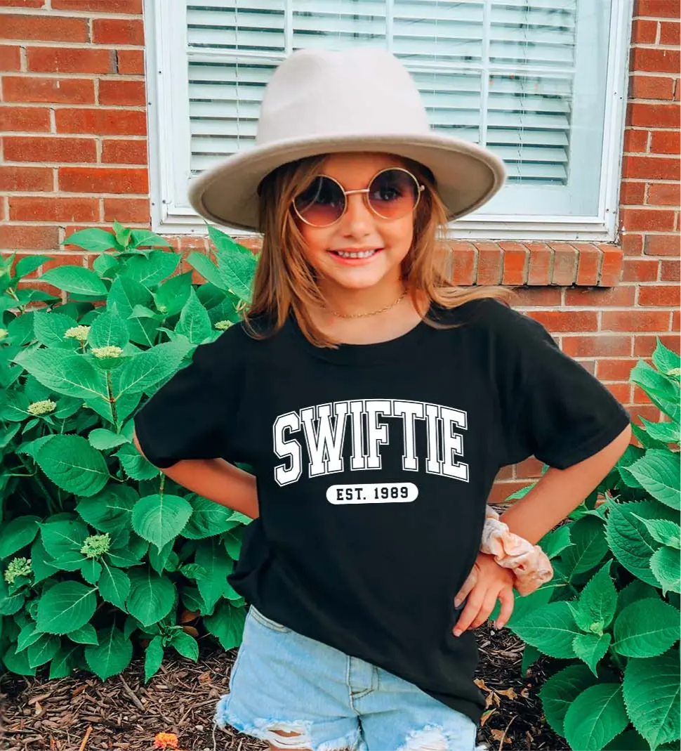 Girl wearing Taylor Swiftie Kids Graphic Tee Black 