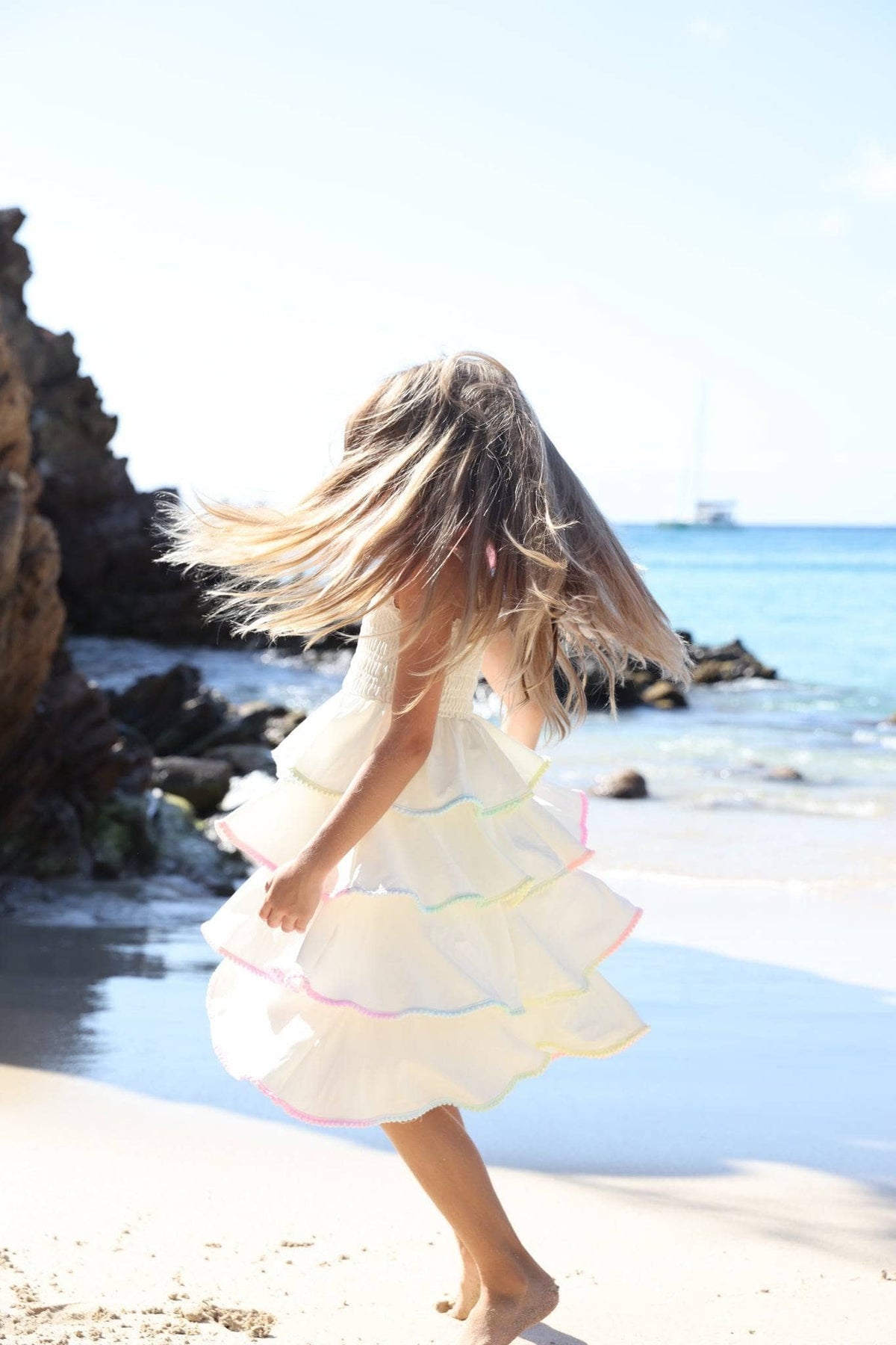 Model Wearing Lola and the Boys Rainbow Tiered Bow Dress