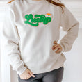 Load image into Gallery viewer, Model wearing Sweet Wink Lucky Rainbow Patch St. Patrick's Day Adult Sweatshirt - Natural
