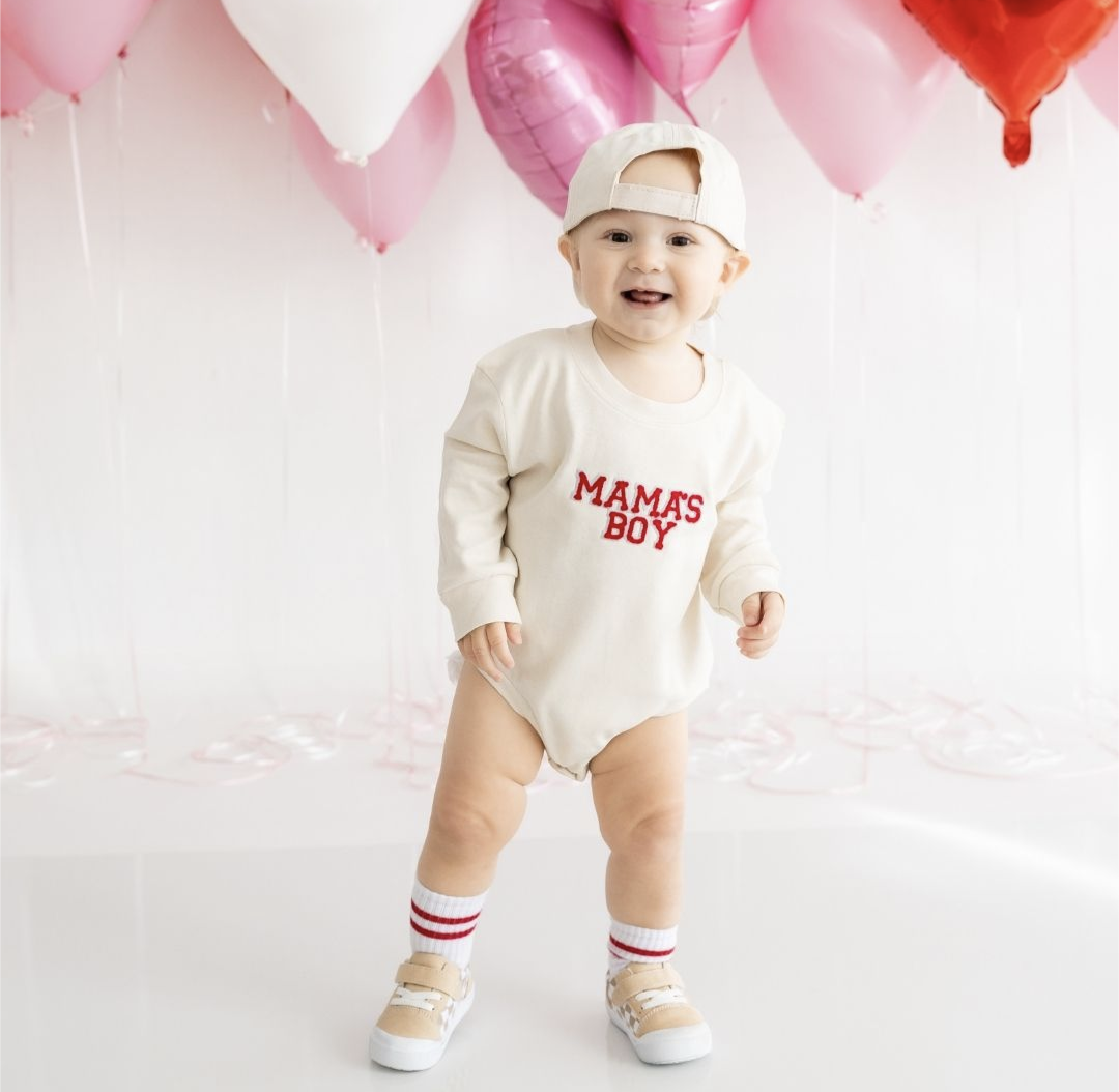 Model Wearing Sweet Wink Mama's Boy Valentine's Day Long Sleeve Bodysuit - Natural