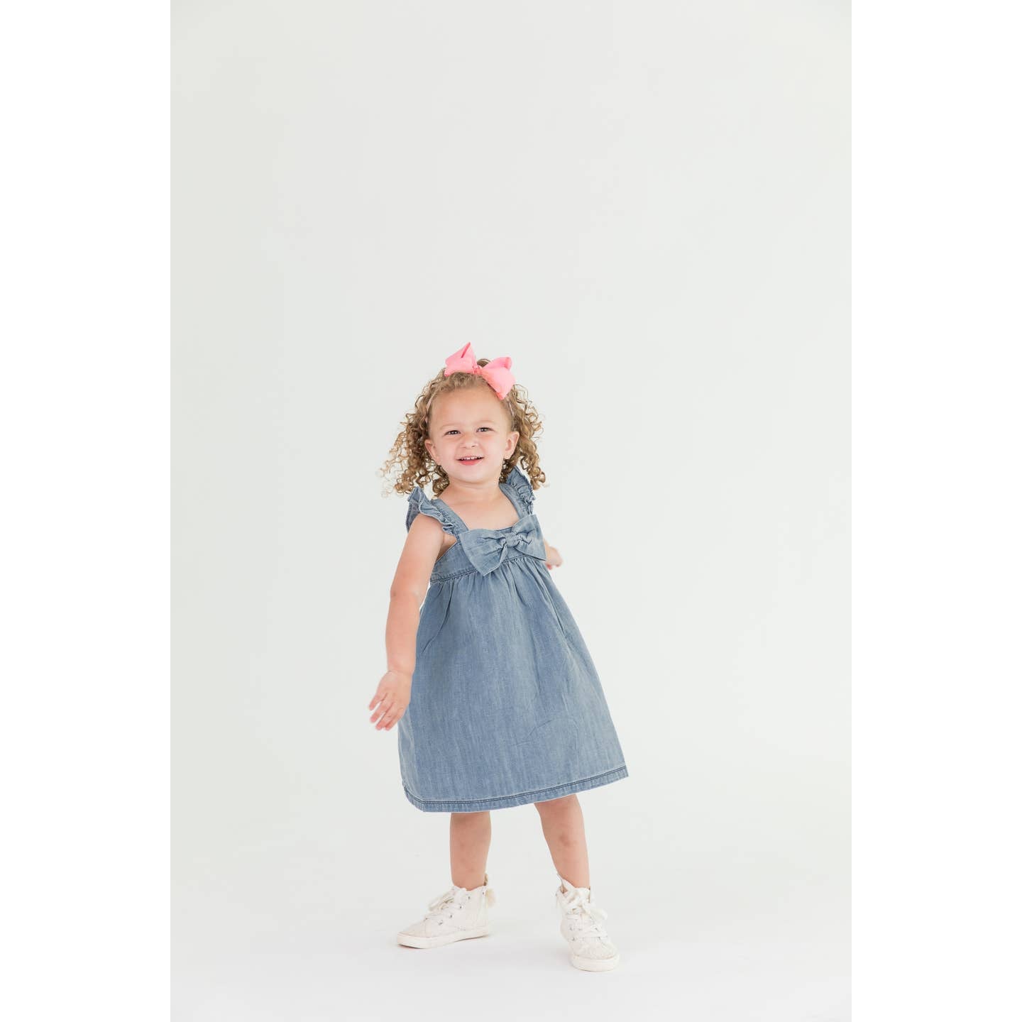 Model Wearing Rufflebutts & Ruggedbutts Girls Light Wash Denim Flutter Bow Woven Dress 