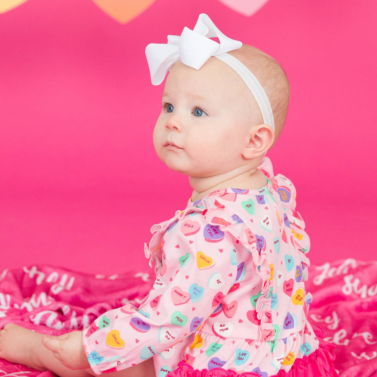 Model Wearing Rufflebutts + Ruggedbutts Baby Girls Be My Valentine Knit Long Sleeve Waterfall Bubble Romper