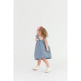 Load image into Gallery viewer, Model Wearing Rufflebutts & Ruggedbutts Girls Light Wash Denim Flutter Bow Woven Dress 
